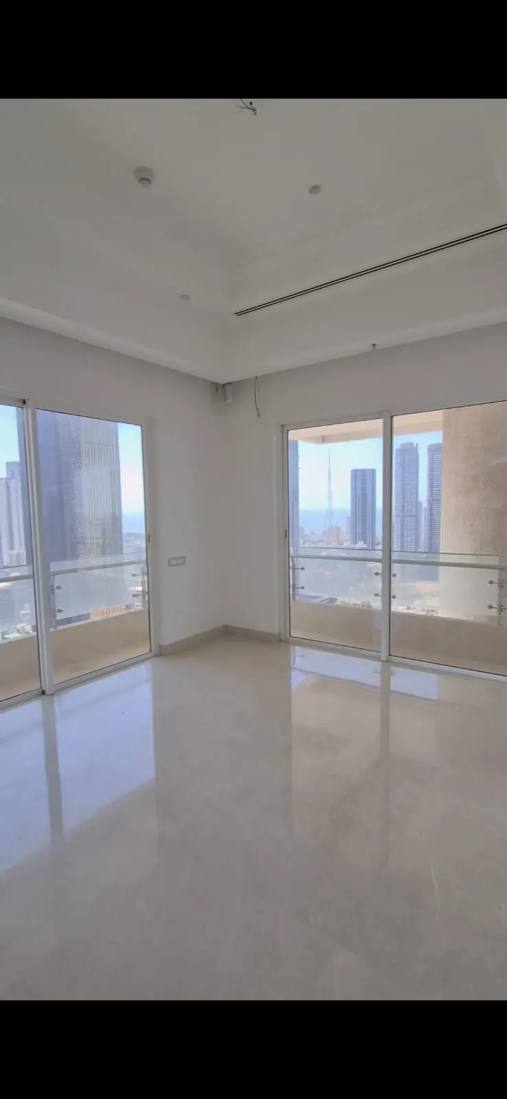 Indiabulls Sky Forest: A builder-finished room with sliding doors to the terrace