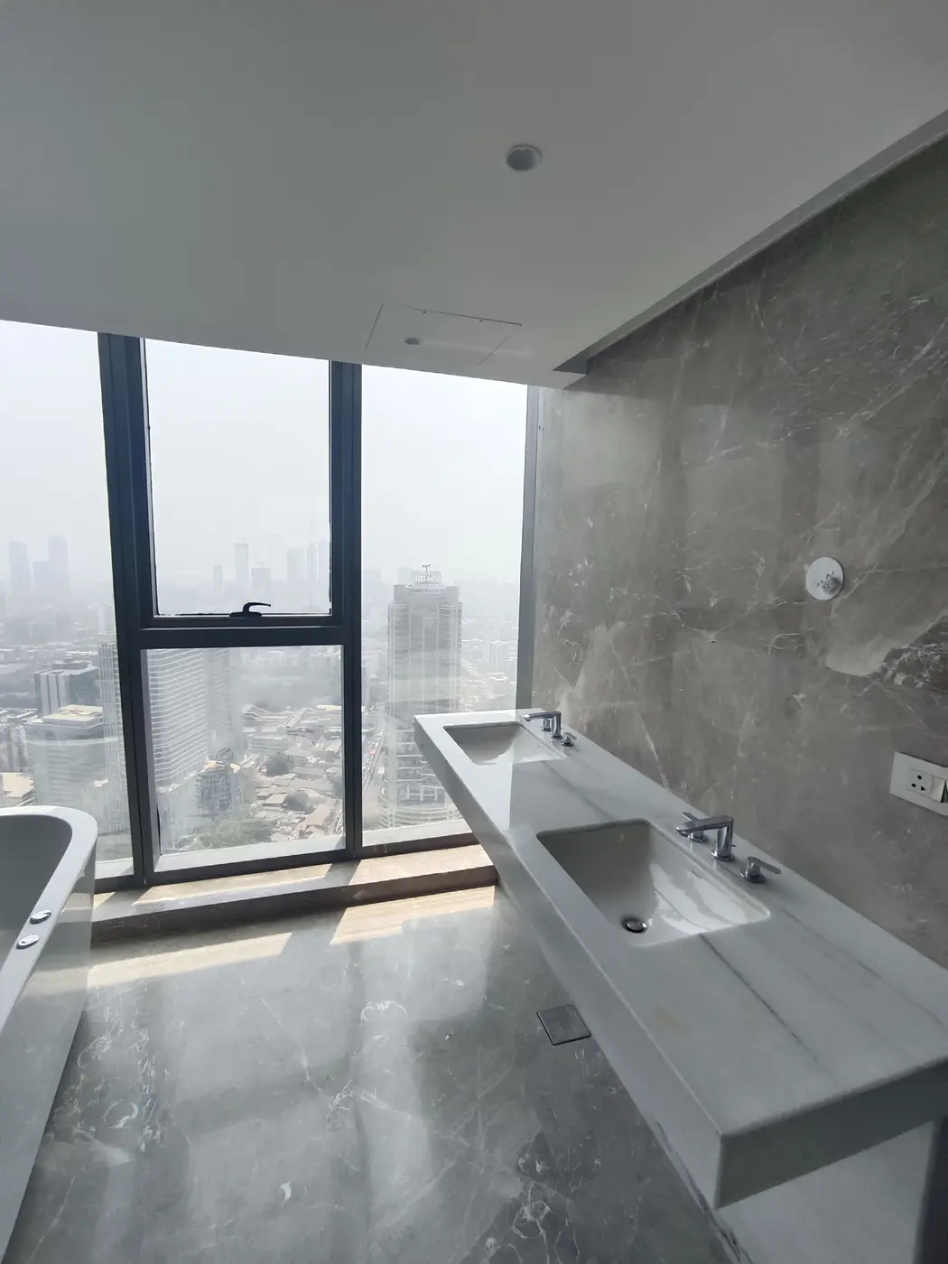 Rustomjee Crown: A bathroom with twin basins by the window